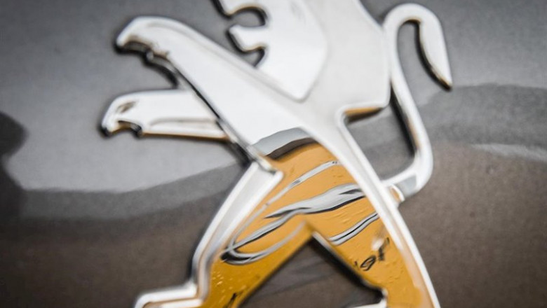 ep filed - 06 march 2017 hessen darmstadt an opel logo is reflected in a peugeot logo on the hood of ep filed - 06 march 2017 hessen darmstadt an opel logo is reflected in a peugeot logo on the hood of