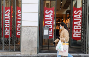 ep archivo   una mujer pasa por delante de un establecimiento en rebajas