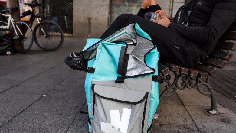 Archivo - Fotografía de un repartidor de la empresa de reparto Deliveroo sentado en un banco de una calle del centro de Madrid. | Jesús Hellín - Europa Press - Archivo ep archivo fotografia de un repartidor de la empresa de reparto deliveroo sentado en un banco de