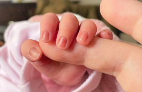 ep archivo   un bebe de pocos dias de edad coge el dedo de su madre