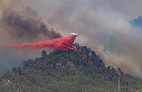ep un hidroavion descarga retardante sobre las llamas de un incendio forestal a 17 de julio de 2022