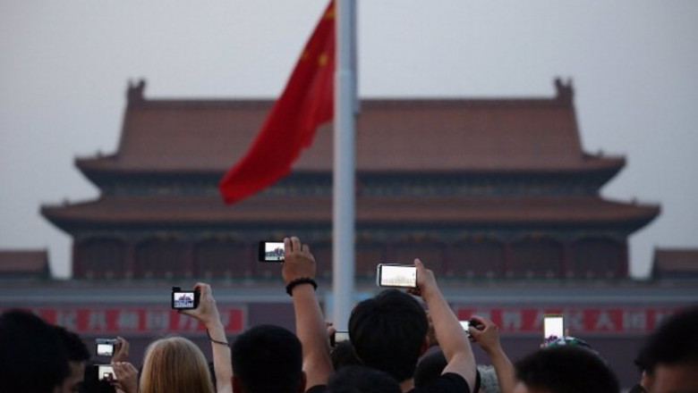 ep chinese tourists watch the customary ceremony of lowering flag at tiananmen square on june 3 2013 ep chinese tourists watch the customary ceremony of lowering flag at tiananmen square on june 3 2013