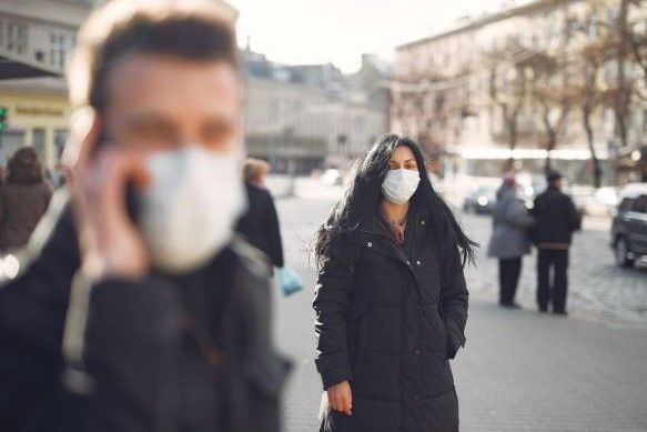 1586161582 canva woman in black coat and face standing on street 1586161582 canva woman in black coat and face standing on street