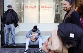 ep varias personas delante del escaparate de una tienda con descuentos de hasta el 50 a 7 de enero