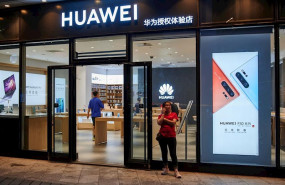 ep august 10 2019 - beijing china a woman talks on a mobile phone outside a huawei store despite