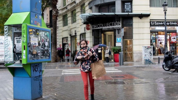 ep una chica pasea por la calle abrigada con bufanda y abrigo durante el peor temporal del otono del